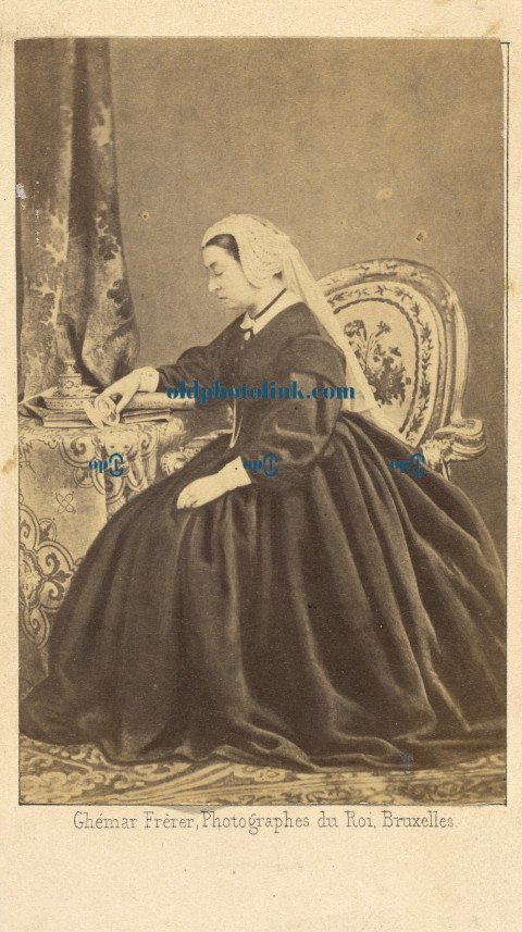Portrait of Queen Victoria seated, gazing at a photograph of Prince Albert 1862
