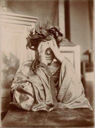 Woman leaning on a table, hands in front of her face 1902